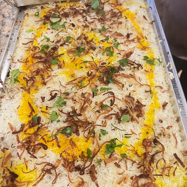 Hyderabadi dum biryani layered with saffron rice and fried onions